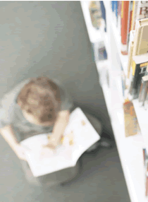 Boy reading library.