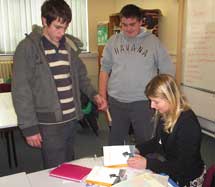 John and Tom from the Voctional Access Programme at City of Bristol College with workshop leader Claire Williamson looking at Refugee Boy.