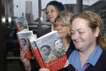 Maureen Twose of Cornwall Libraries with two staff members at Treliske Hospital, Truro, Cornwall.