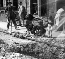 Children looking for shrapnel after raid.